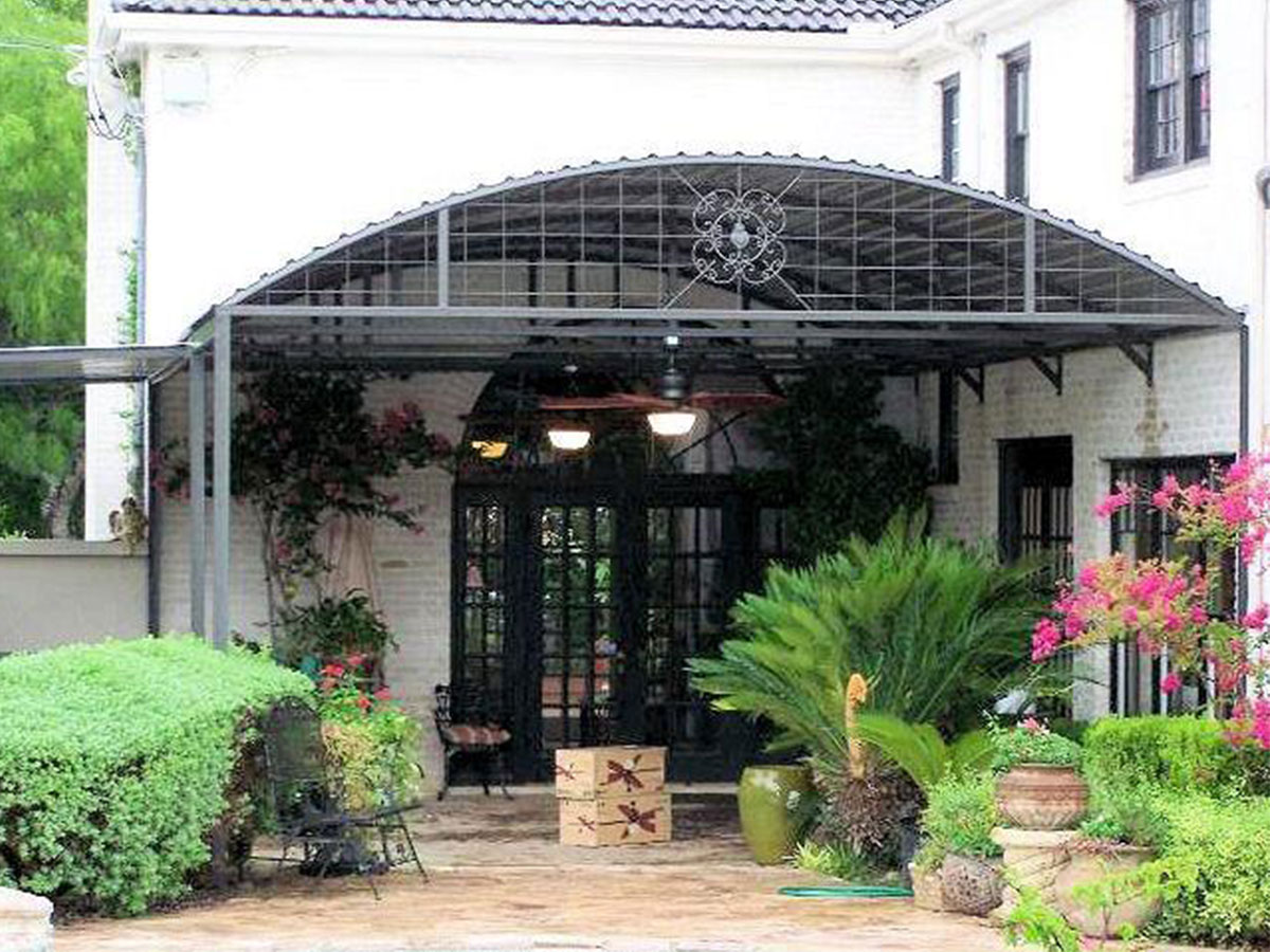 Curved steel awning attached to a house in Alamo Heights, Texas
